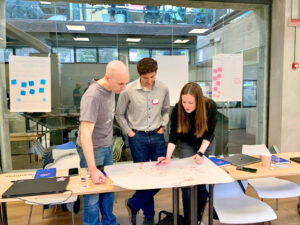group activity during a workshop, two men and one woman talking