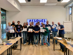 a group of people taking a group picture with a certificate after a workshop