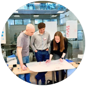 a woman e two men during a training class