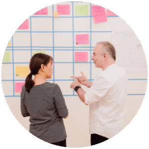 a man and a woman in front of a wall during an open space technology