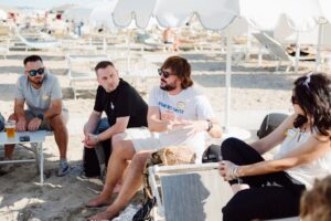 people speaking at the beach
